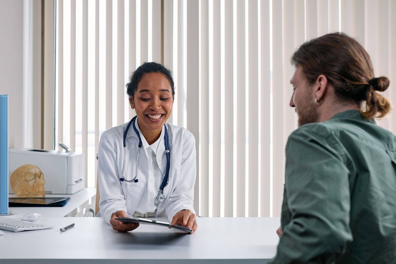 A clinician listening to a patient during a consultation