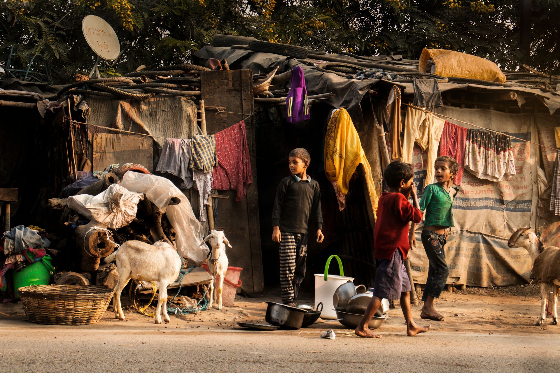 Children standing outside a home in a community where access to care is limited